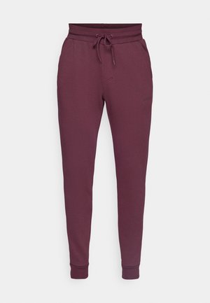 Burgunderfarbene Jogginghosen aus Baumwollmischung mit einem Kordelzugbund, zwei Seitentaschen und elastischen Bündchen an den Knöcheln.