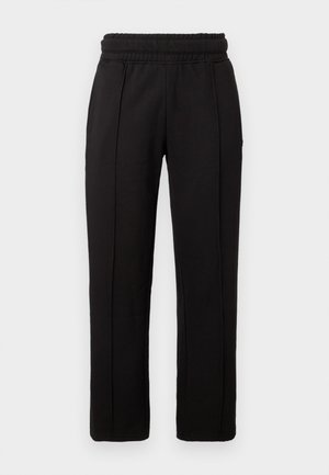 Pantalon noir à jambes droites avec ceinture élastique et détails de coutures visibles à l'avant, sur un fond uni.