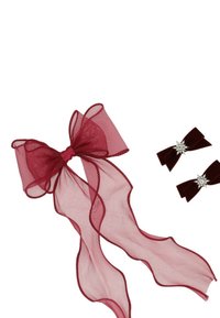 Fiocco in organza trasparente bordeaux con code in nastro, accompagnato da due fermagli in velluto rosso scuro decorati con abbellimenti a forma di esplosione d'argento.