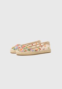 Bestickte Leinen-Espadrilles mit einer Sohle aus Jute-Seil. Mit bunten Blumenmustern auf hellbeigem Stoff, im Slip-On-Design und flacher Bauweise.