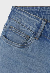Un jean en denim bleu clair avec une poche arrière, présentant des détails de couture et une texture lisse. La taille a un léger effet de décoloration.