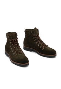 Dark brown suede ankle boots with brown patterned laces, metal eyelets, padded collar, and black rubber tread soles.