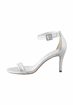 Silver high-heeled sandal with a slim ankle strap, open toe, and a smooth metallic finish. Features a modest block heel and minimalist design.
