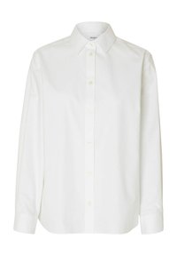 Camisa blanca de manga larga en tela de algodón, con un cuello clásico, cierre de botones frontal y un corte holgado con dobladillo ligeramente redondeado.