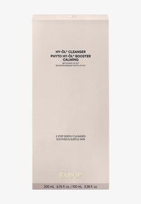 Boîte de nettoyant Babor Hy-Öl, beige clair avec finition mate. Texte noir affichant les détails du produit, accent doré pour le nom de la marque. Taille indiquée de 200 mL.