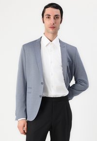 Light blue suit jacket made of textured fabric, featuring notched lapels, single button closure, two front pockets, and paired with a white shirt.