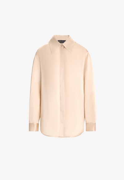 Beige silk blouse with a pointed collar, long sleeves, and a button-down front. Features a smooth, shiny texture and rounded hem.