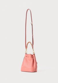 Saco em forma de balde de couro rosa com superfície texturizada, alça ajustável e detalhes em hardware dourado. Apresenta um detalhe em corrente trançada na pega.
