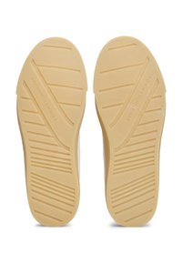 Light beige rubber shoe soles with textured grip patterns and logo detailing. Features horizontal and diagonal ribbing for traction.