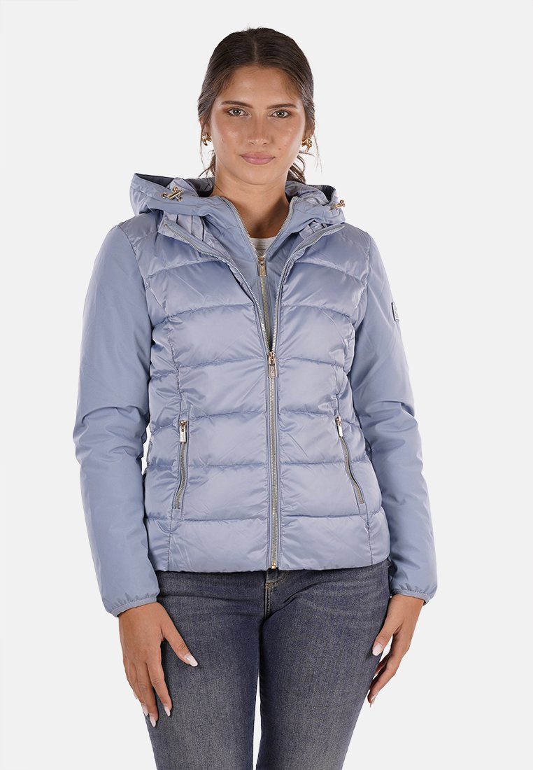 Giacca imbottita blu chiaro con cappuccio, chiusura frontale con zip e due tasche laterali. Presenta un design trapuntato e polsini elasticizzati.