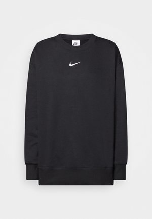 Melna džemperis ar apaļu kakla izgriezumu, garām piedurknēm un baltu Nike logo vidū uz krūts. Izgatavots no mīksta, teksturēta auduma.