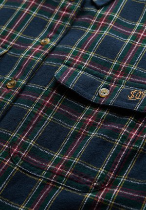 Flanel overhemd met een marineblauwe basis en een multicolor ruitpatroon in groen, rood en geel. Inclusief ronde zak en messing knopen.