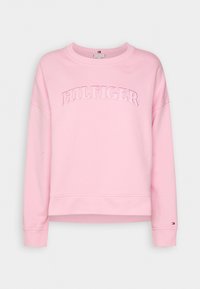 Pink sweatshirt with ribbed cuffs and hem, featuring an embroidered 'HILFIGER' logo across the chest. Soft texture, casual fit.