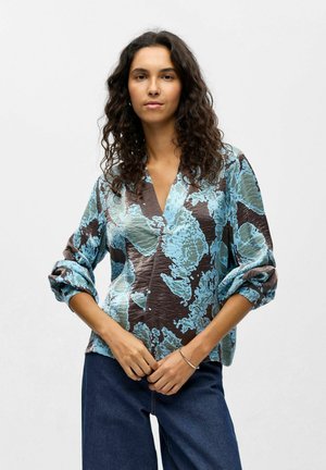 Blau- und braun gemustertes Shirt mit V-Ausschnitt, langen Ärmeln und lockerer Passform; verfügt über einen strukturierten Stoff mit floralem Design.
