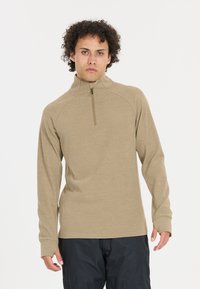 Beige langærmet top med lynlås krave, lavet af blødt stof. Har raglanærmer og tætsiddende manchetter. Minimalistisk design uden mønstre.