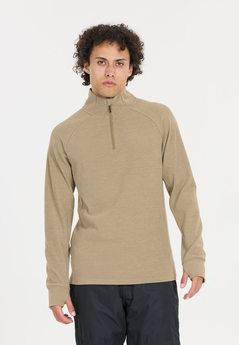 Beige langærmet top med lynlås krave, lavet af blødt stof. Har raglanærmer og tætsiddende manchetter. Minimalistisk design uden mønstre.