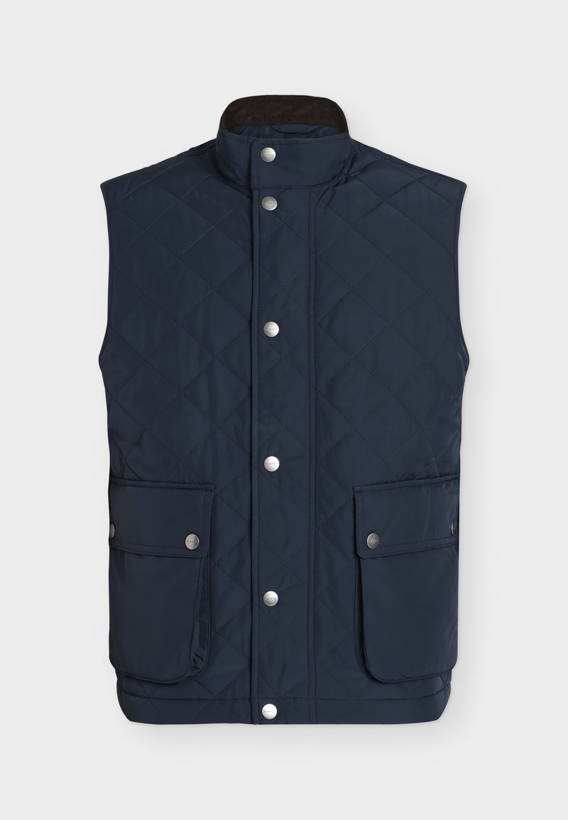 Marineblå, quiltet, ærmeløs vest med stående krave, frontknapper og to store klaplommer med tryklåse.