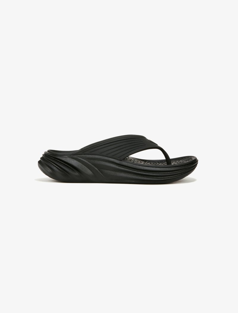Black rubber flip-flop with a textured footbed, curved sole, and a slender strap. Features pronounced grooves and smooth accents.