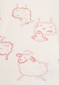Baumwollstoff mit einem weichen weißen Hintergrund, der verspielte Illustrationen von Schafen in hellen Rosa- und Brauntönen zeigt.
