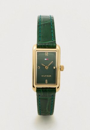 Rectangular gold-tone watch with a green dial, gold accents, and a green croc-embossed leather strap with blue stitching. Brand name: Hilfiger.