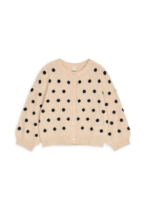 Cardigan beige en tricot avec des pois noirs duveteux, manches longues bouffantes, fermeture par boutons et poignets et ourlet côtelés.