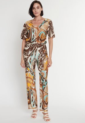 Brown patterned jumpsuit with a v-neck, short sleeves, and an elastic waist. Features colorful abstract designs in orange and teal.