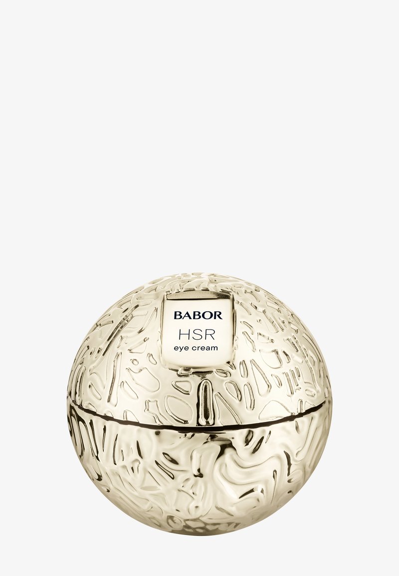 Złote, okrągłe opakowanie o teksturowanej powierzchni z białą etykietą z napisem „Babor HSR krem pod oczy”. Wieczko rozdziela się na pół.