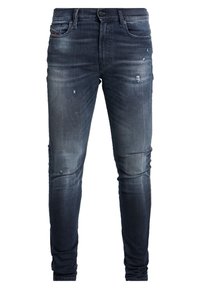 Mörkblå denimjeans med en blekt finish, slim fit-design, slitna detaljer med ljusa whiskers och femfickors-stil.