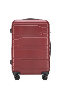 Valise rigide rouge avec une finition texturée, dotée d'une fermeture éclair, d'une poignée supérieure et de quatre roues noires pour plus de mobilité.