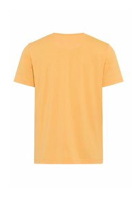 T-shirt à manches courtes uni de couleur orange clair, présenté de dos sur un fond blanc.
