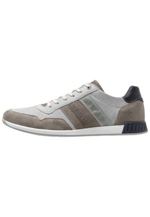 Sporty sneaker in gray and light gray suede and leather. Features textured accents, rounded toe, flat white sole, and logo detailing on the side.