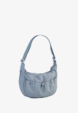 Light blue fabric bag with a curved shape, adjustable strap, and a front pocket with a toggle closure. Smooth texture with minimal design.