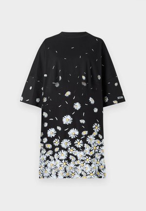 T-shirt noir, coupe ample, manches courtes, orné de motifs de marguerites blanches et jaunes au bas, tissu doux, col rond.