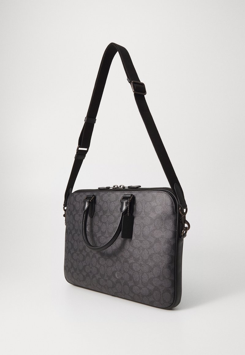 Borsa per laptop nera realizzata in materiale testurizzato, con un motivo geometrico, doppi manici superiori e una tracolla staccabile. Chiusura con zip.