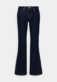 Jean en denim bleu foncé, taille haute et jambes évasées, fermeture devant par boutons et zip, avec surpiqûres contrastantes.