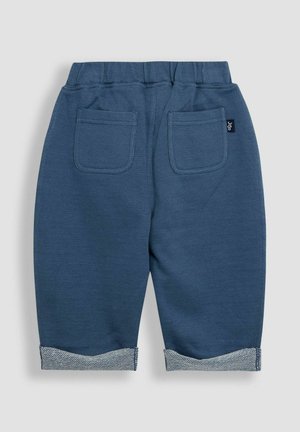 Blaue Baumwollhosen mit entspanntem Schnitt, umgeschlagenen Säumen in einem kontrastierenden Muster und zwei Gesäßtaschen. Elastischer Bund für zusätzlichen Komfort.