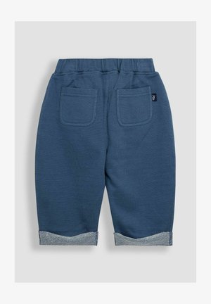 Pantaloni in cotone blu con vestibilità rilassata, orli risvoltati in un motivo contrastante e due tasche posteriori. Vita elasticizzata per il massimo comfort.