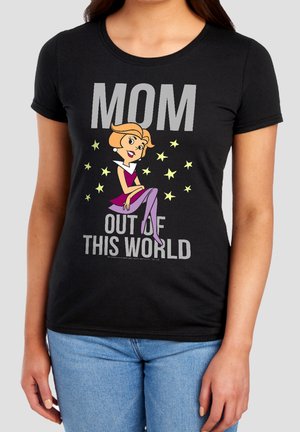 Woman wearing black t-shirt with cartoon woman, yellow stars, and text "MOM OUT OF THIS WORLD" on the front.