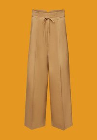 Beige wide-leg trousers with a drawstring waist, two side pockets, and a smooth texture, shown against an orange background.
