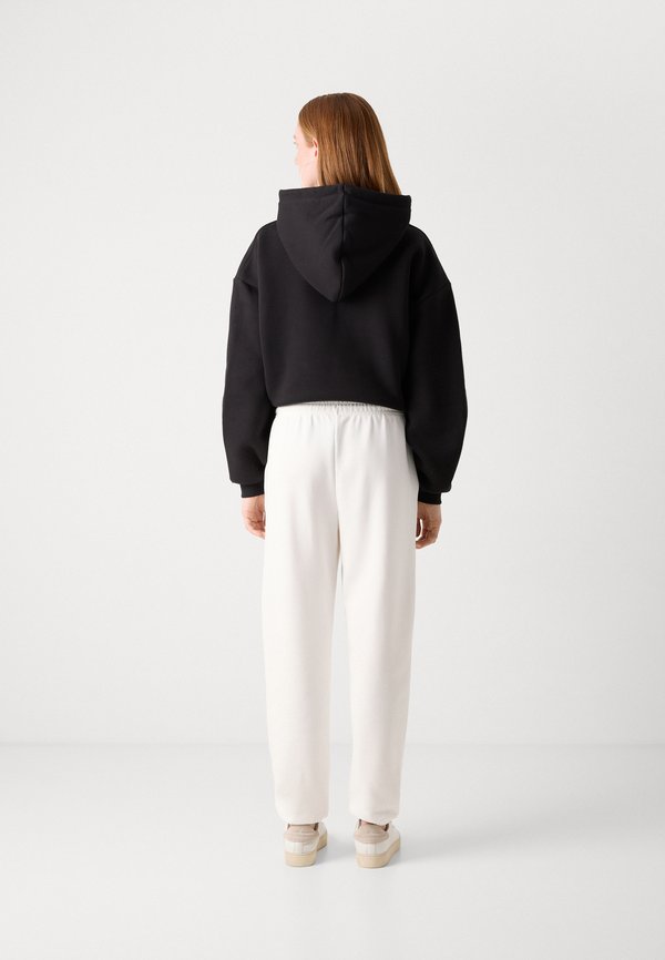 TONAL SHIELD - Tracksuit bottoms - eggshell2