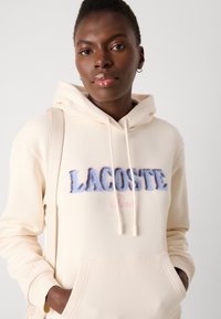 Lacoste Kapuutsiga pusa - lapland