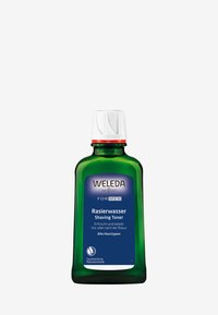 Weleda Scheer Tonic in een groene glazen fles met een witte dop. Heeft een blauwe label met tekst in het Duits en het Engels. 150 ml formaat.