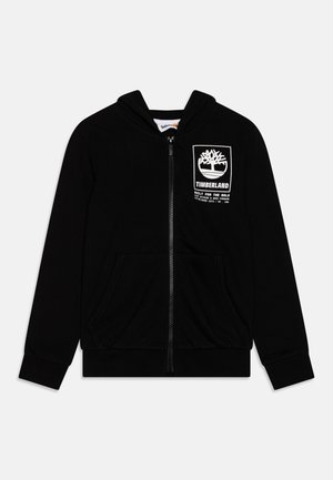 Hoodie zippé noir en tissu doux. Présente un patch logo sur le devant avec un design d'arbre et deux poches latérales. Manches et ourlet côtelés.
