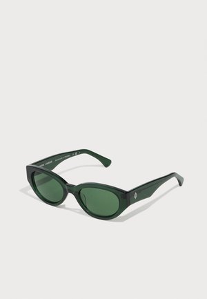 Green sunglasses with a glossy finish, oval lenses, and thick rectangular frames. Features subtle branding on the outer arms.