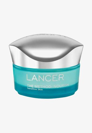LANCER De Methode: Voedende crème in een ronde heldere turquoise pot met een zilver reflecterende deksel, gelabeld voor gevoelige huid.