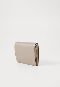 Light beige leather wallet with a textured finish, featuring a folded design and visible card slots on the inside.