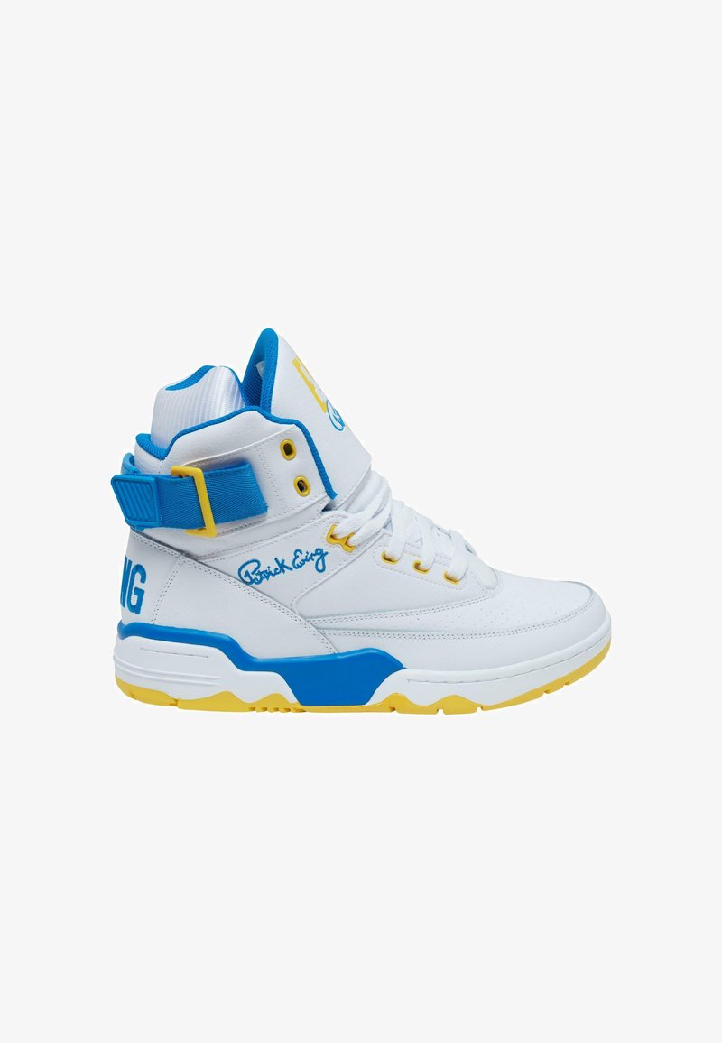 Valged kõrgema säärega tossud siniste aktsentidega. Omavad perforatsiooni tekstuuri, kollast tallaga ja sinist brändimärki. Lisatud on rihm kindlaks kinnitamiseks.