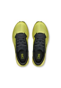 Lime green athletic shoes with a black mesh upper, featuring a cushioned sole, contrasting laces, and a logo on the tongue and insole.