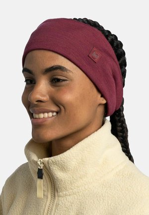 Maroon fabric headband with a smooth texture, featuring a small circular logo patch and worn with a beige fleece jacket.