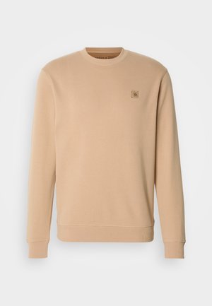 Beige Sweatshirt mit Rundhalsausschnitt, langen Ärmeln, gerippten Bündchen und Saum, mit einem kleinen gestickten Logo auf der Brust. Weiches Baumwollmaterial.
